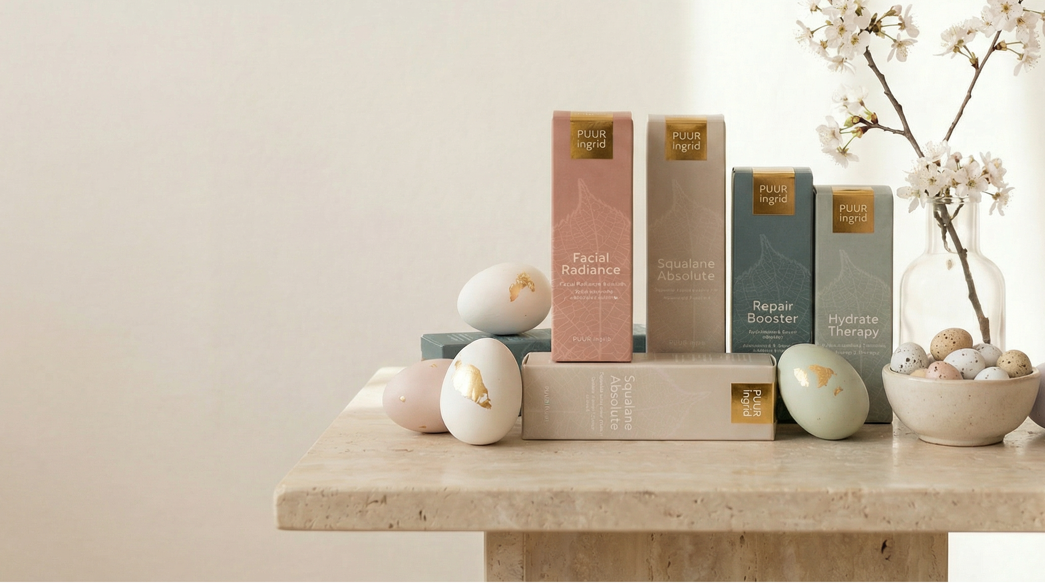 Decorative items including books, eggs, and a vase with flowers on a light surface.